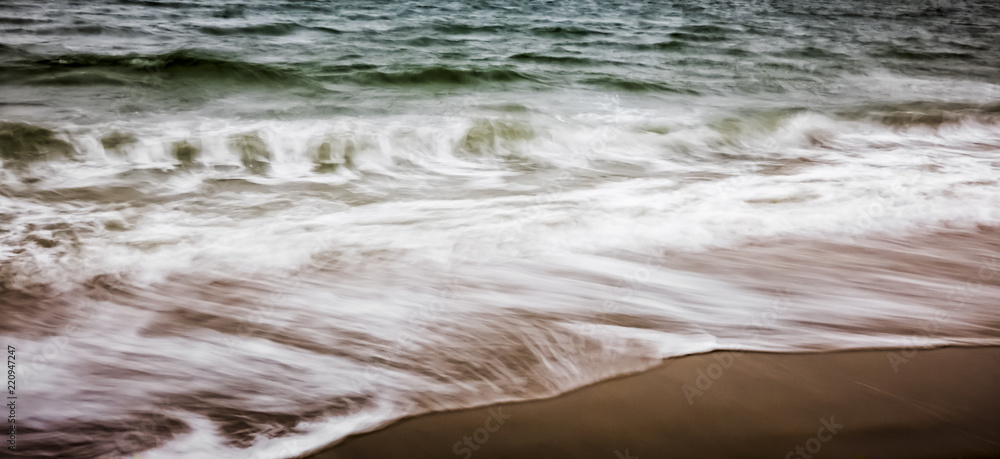 artistic moving blurred background of the foam of the waves that wash up on the beach artistic moving blurred background of the foam of the waves that wash up on the beach