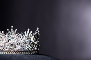 Diamond Silver Crown for Miss Pageant Beauty queen Contest, Crystal Tiara jewelry decorated gems stone and abstract dark background on black velvet fabric cloth, Macro photography copy space