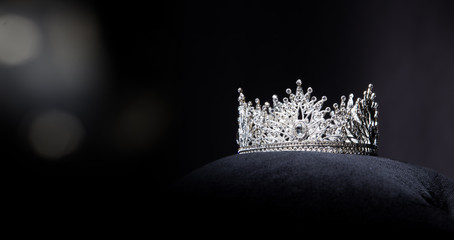 Diamond Silver Crown for Miss Pageant Beauty queen Contest, Crystal Tiara jewelry decorated gems stone and abstract dark background on black velvet fabric cloth, Macro photography copy space