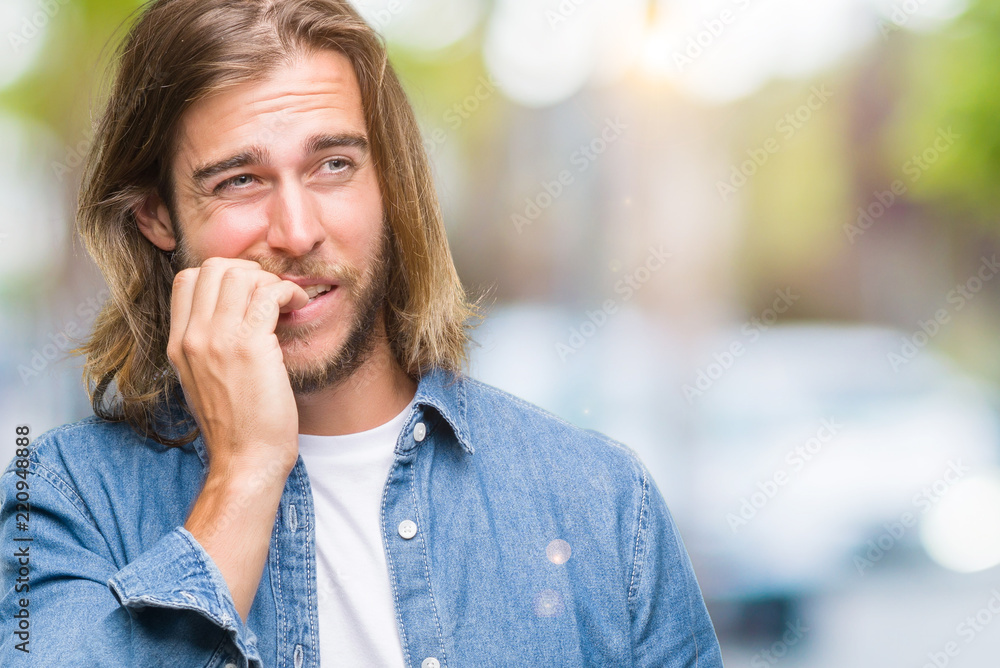 Young handsome man with long hair over isolated background looking stressed and nervous with hands on mouth biting nails. Anxiety problem. Young handsome man with long hair over isolated background looking stressed and nervous with hands on mouth biting nails. Anxiety problem.