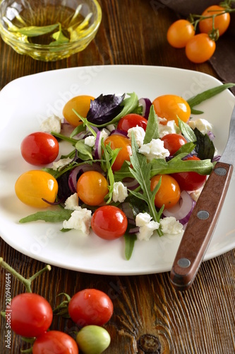 Green salad with cherry tomatoes and cottage cheese, vertical