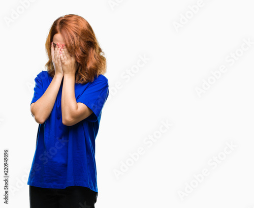 Young beautiful woman over isolated background with sad expression covering face with hands while crying. Depression concept.