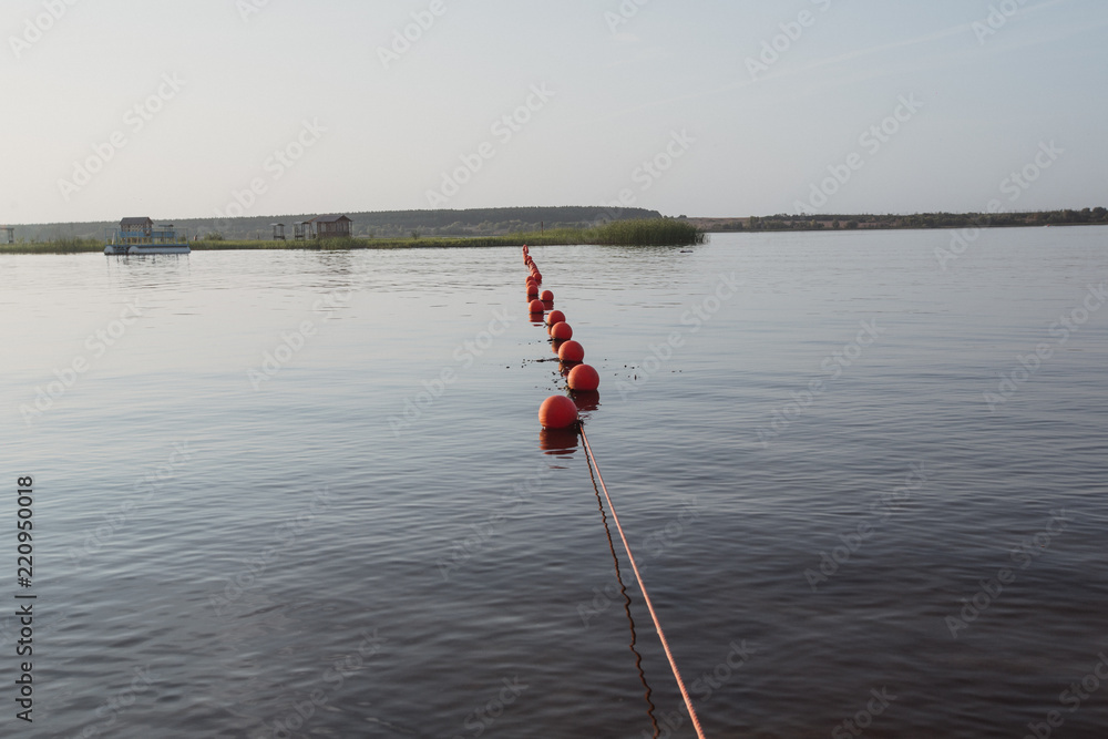 red buoys floating on the river red buoys floating on the river