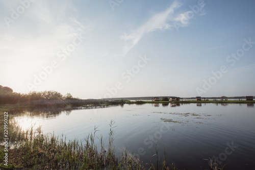 beautiful lake shore on the background of a wooden bridge