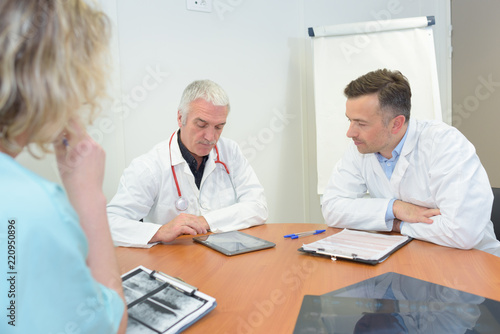group of doctors meeting and taking notes at medical office