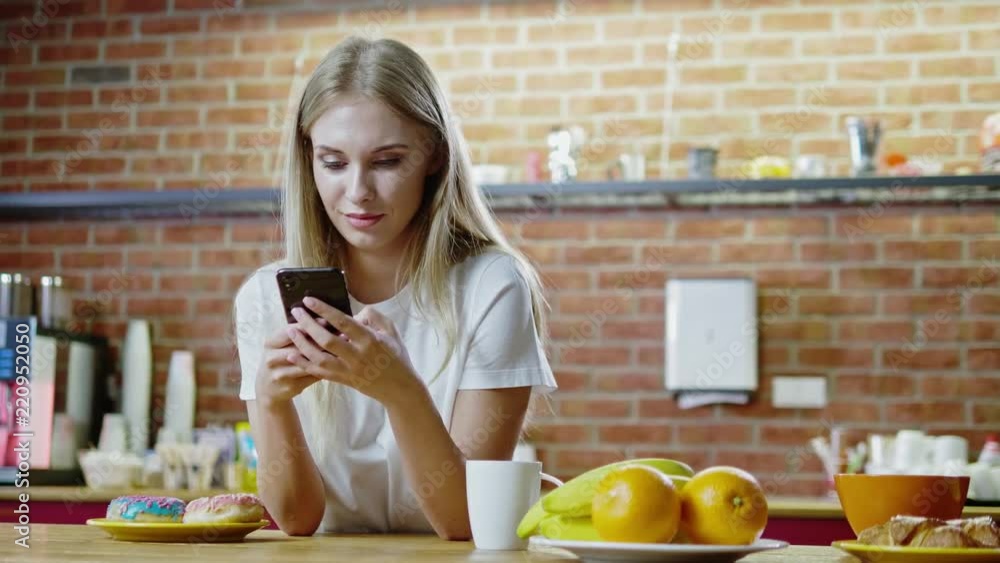 Beautiful young woman having breakfast