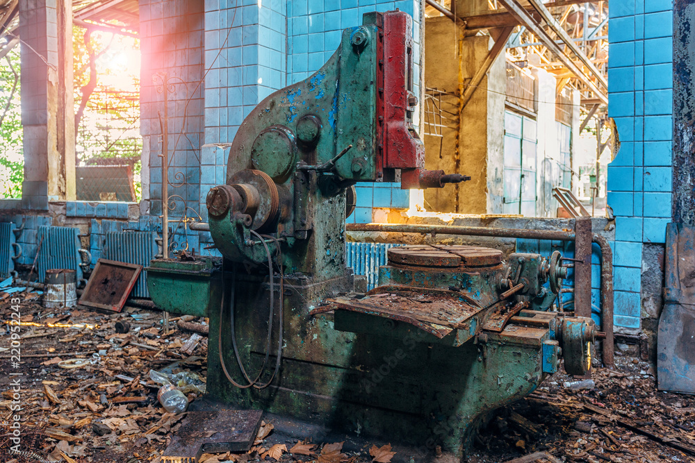 Fototapeta premium Old industrial machine tool in workshop. Rusty metal equipment in abandoned factory