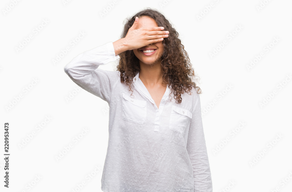 Beautiful young hispanic woman smiling and laughing with hand on face covering eyes for surprise. Blind concept. Beautiful young hispanic woman smiling and laughing with hand on face covering eyes for surprise. Blind concept.