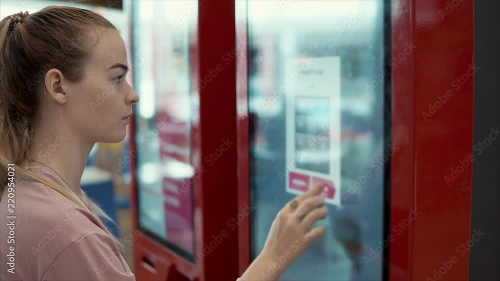Close-up shot of a beautiful woman using digital self-service kiosk to choose and order food. Unhealthy eating, buying fast food on weekends. Close-up shot of a beautiful woman using digital self-service kiosk to choose and order food. Unhealthy eating, buying fast food on weekends.