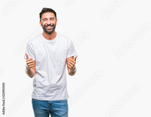 Adult hispanic man over isolated background success sign doing positive gesture with hand, thumbs up smiling and happy. Looking at the camera with cheerful expression, winner gesture.