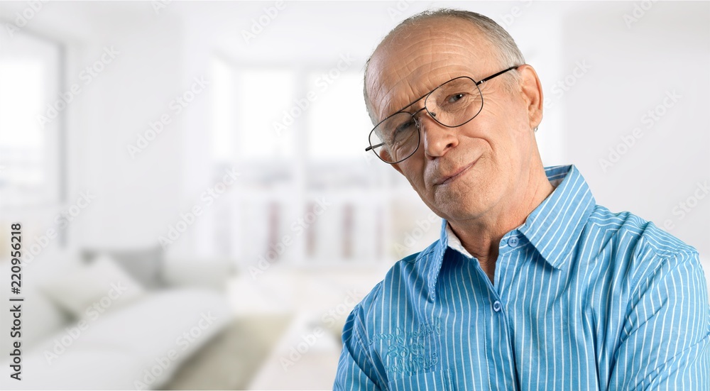 Senior man in blue shirt and glasses