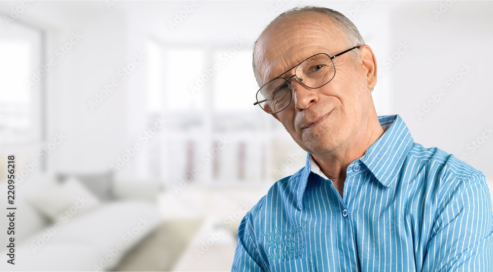 Fototapeta premium Senior man in blue shirt and glasses