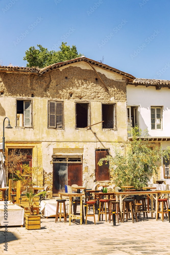 Old house with cafe in the courtyard, blue sky