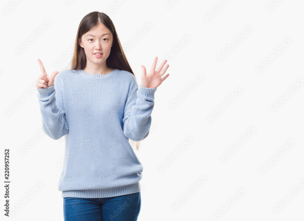 Young Chinese woman over isolated background showing and pointing up with fingers number seven while smiling confident and happy. Young Chinese woman over isolated background showing and pointing up with fingers number seven while smiling confident and happy.
