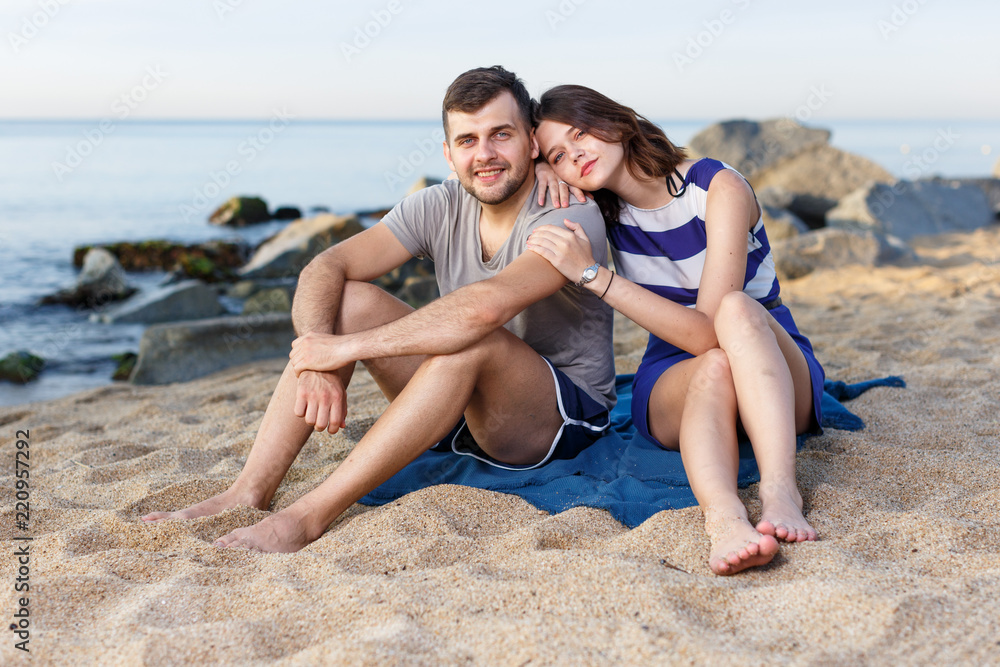 Young loving couple sitting and hugging