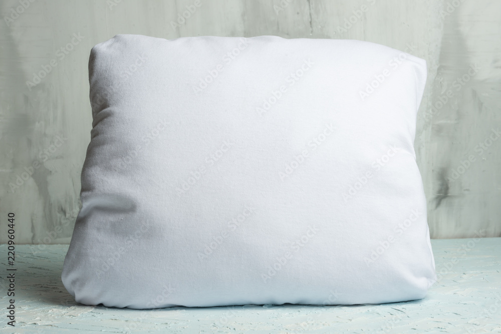 Mockup body cushion. White pillow against the wall. Foreground. Mockup body cushion. White pillow against the wall. Foreground.