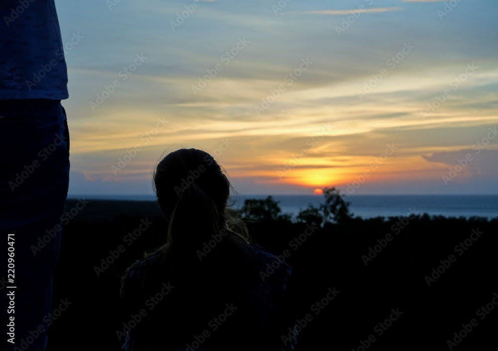 Unknown woman looking at the sunset