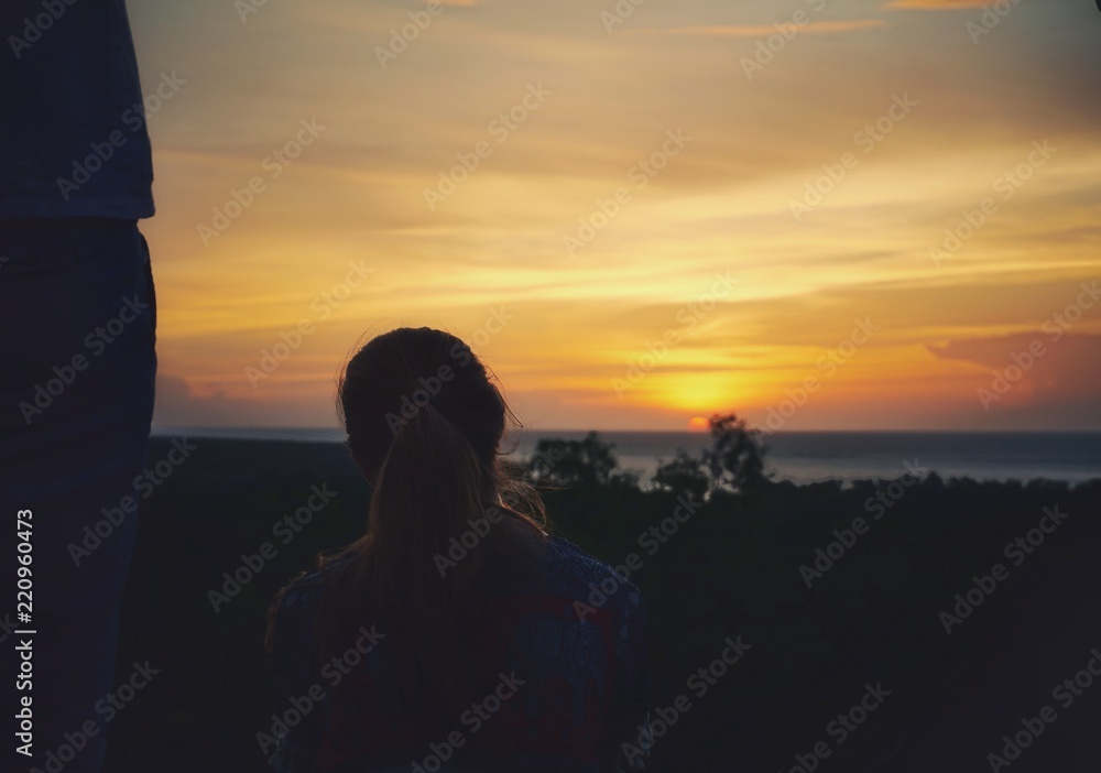 Fototapeta premium Unknown woman looking at the sunset