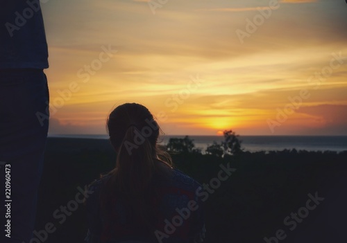 Unknown woman looking at the sunset