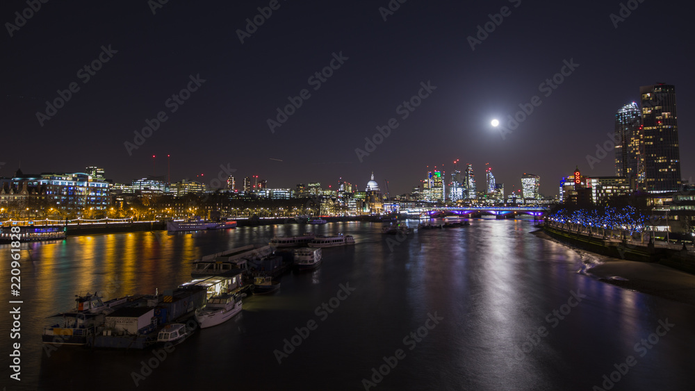 The moon shining brightly over the City of London.