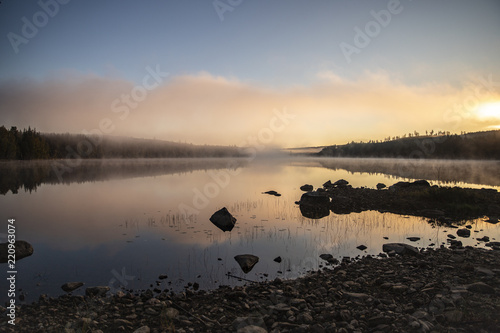 Foggy morning sunrise by the lake