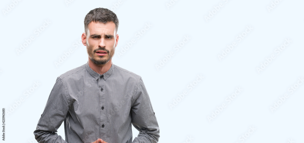Fototapeta premium Young hipster man with hand on stomach because indigestion, painful illness feeling unwell. Ache concept.