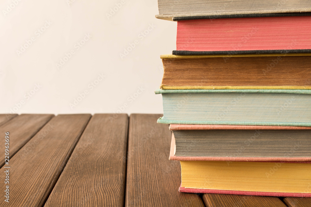 Stack of books on a wooden table. The concept of education and knowledge from books. Close up. With empty space for text Stack of books on a wooden table. The concept of education and knowledge from books. Close up. With empty space for text