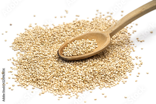 Quinoa seeds on a wooden spoon seen obliquely from above and isolated on white background