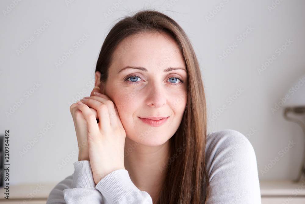 Close up young woman with long hair smiling and staring Close up young woman with long hair smiling and staring