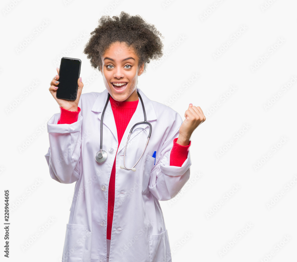 Young afro american doctor woman using smartphone over isolated background screaming proud and celebrating victory and success very excited, cheering emotion Young afro american doctor woman using smartphone over isolated background screaming proud and celebrating victory and success very excited, cheering emotion