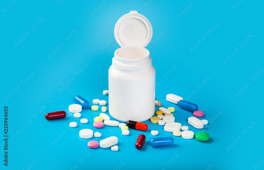 Medicine pills, tablets and capsules over blue background Medicine pills, tablets and capsules over blue background