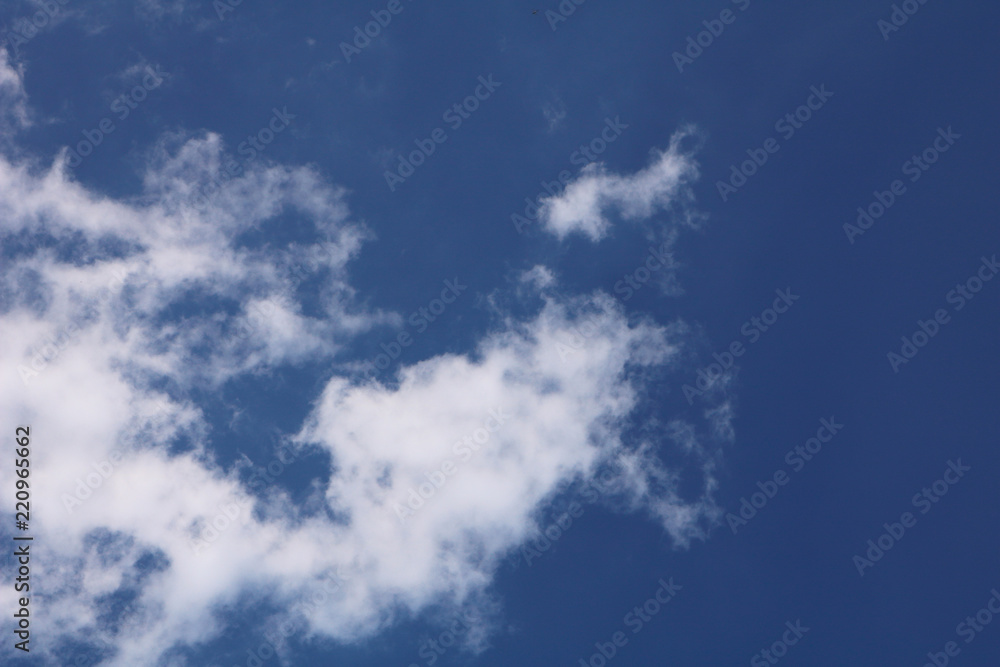 Fototapeta premium Blue sky with tiny few white clouds - background