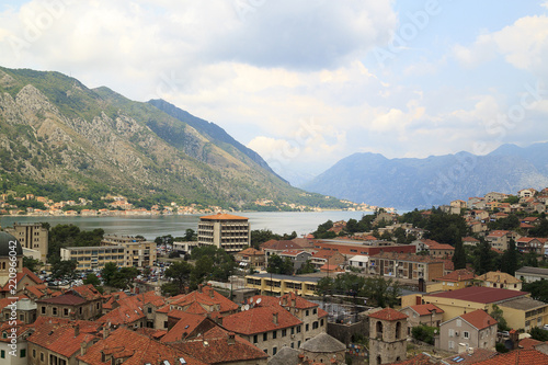 view of medieval tiled roofs of stone houses with windows and wooden shutters in the old town of Kotor, Montenegro