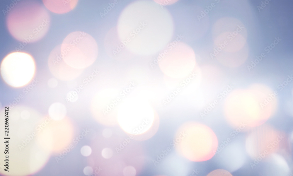 Fototapeta premium Winter blurry background in light blue pink tones. Christmas lights defocused with beautiful light, abstract snowflakes in blur, copy space.