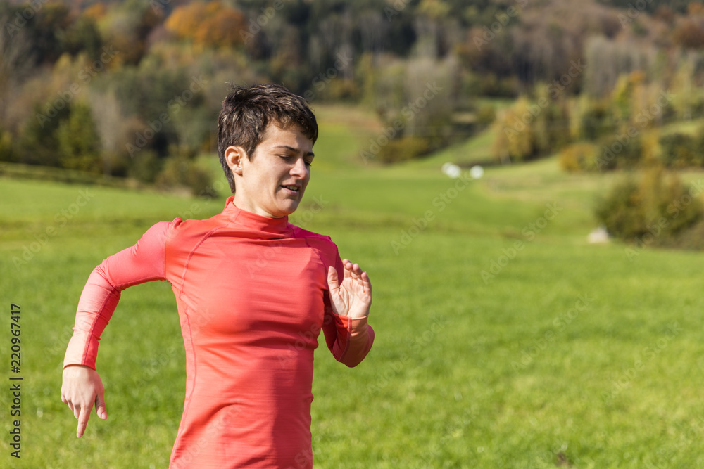 A woman running outdoors in the countryside of Bavarain National Forest Park A woman running outdoors in the countryside of Bavarain National Forest Park