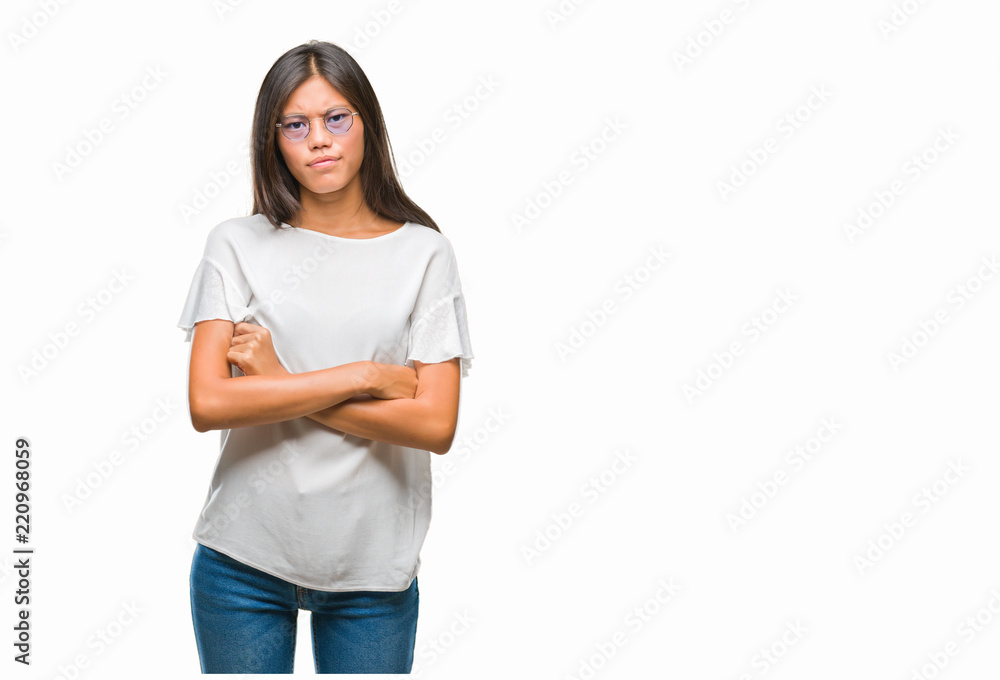 Young asian woman wearing glasses over isolated background skeptic and nervous, disapproving expression on face with crossed arms. Negative person. Young asian woman wearing glasses over isolated background skeptic and nervous, disapproving expression on face with crossed arms. Negative person.