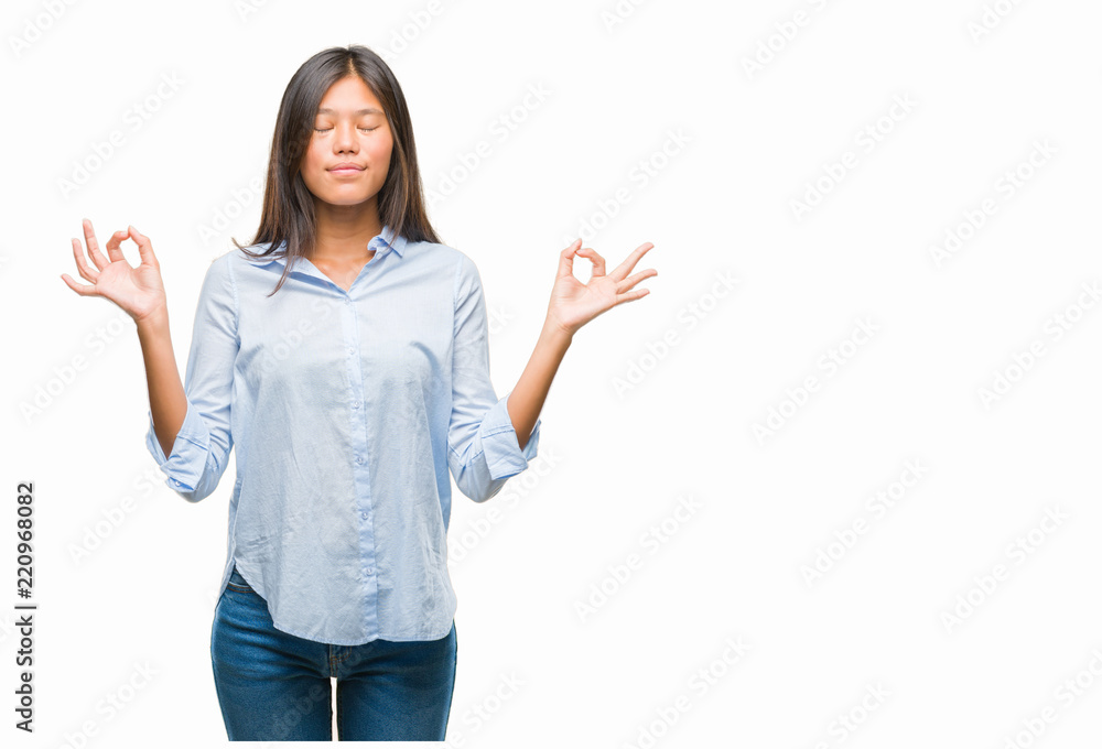 Young asian business woman over isolated background relax and smiling with eyes closed doing meditation gesture with fingers. Yoga concept. Young asian business woman over isolated background relax and smiling with eyes closed doing meditation gesture with fingers. Yoga concept.