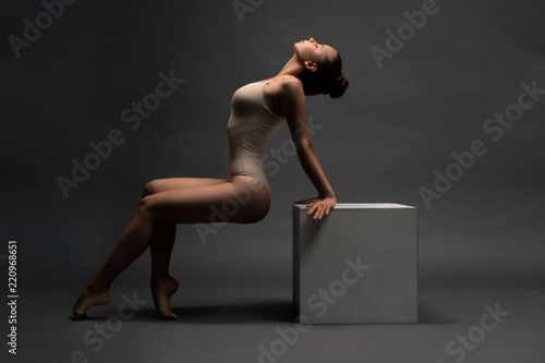 Obraz na plátne Sexy girl in beige body arching her back view