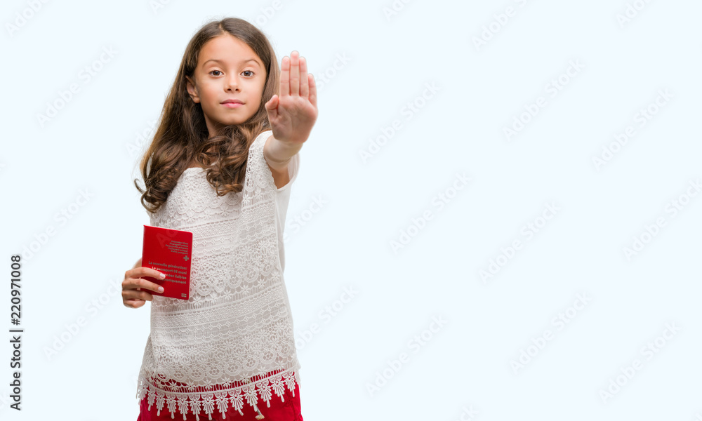 Obraz premium Brunette hispanic girl holding passport of Switzerland with open hand doing stop sign with serious and confident expression, defense gesture