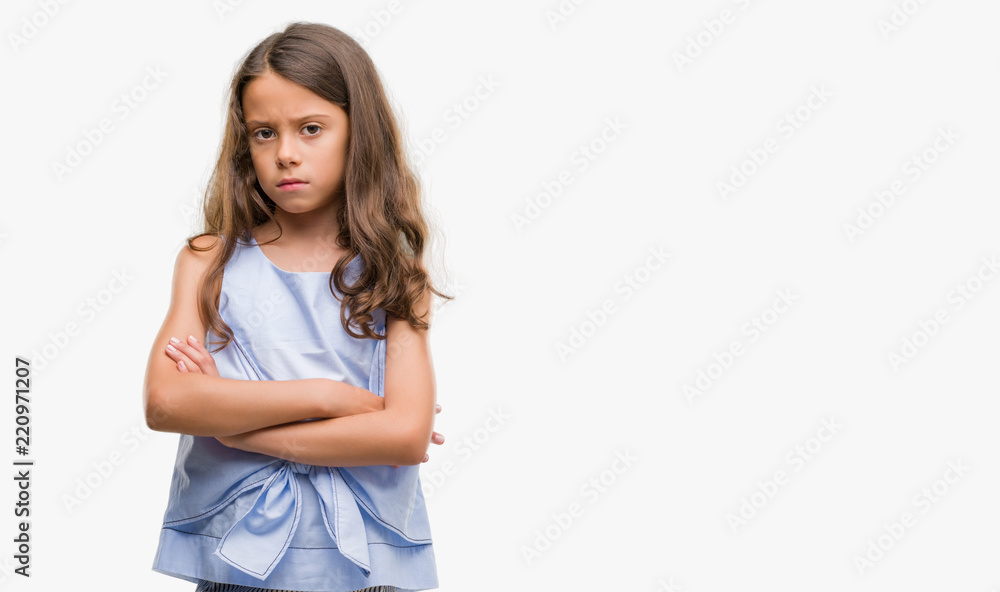 Brunette hispanic girl skeptic and nervous, disapproving expression on face with crossed arms. Negative person. Brunette hispanic girl skeptic and nervous, disapproving expression on face with crossed arms. Negative person.