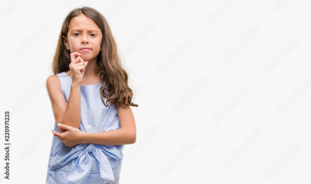 Brunette hispanic girl with hand on chin thinking about question, pensive expression. Smiling with thoughtful face. Doubt concept. Brunette hispanic girl with hand on chin thinking about question, pensive expression. Smiling with thoughtful face. Doubt concept.