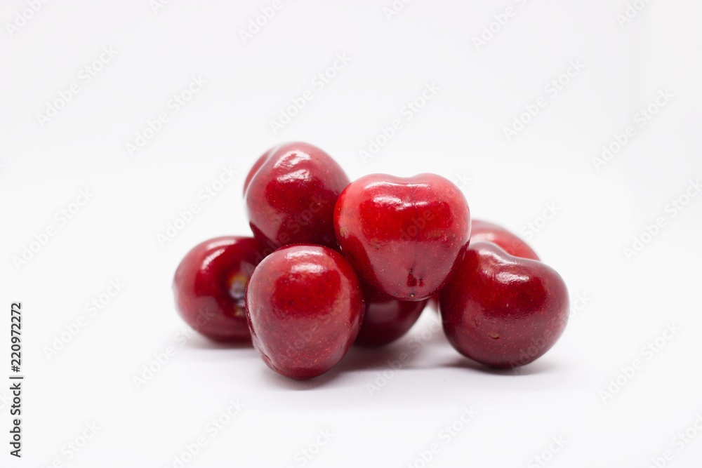 pile of cherries on white