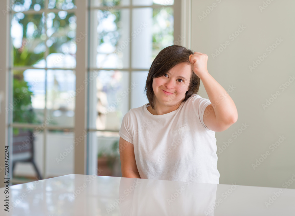 Down syndrome woman at home annoyed and frustrated shouting with anger, crazy and yelling with raised hand, anger concept Down syndrome woman at home annoyed and frustrated shouting with anger, crazy and yelling with raised hand, anger concept