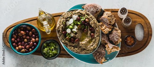 banner of Appetizer with baba ganush of eggplant, olives from kalamata, green onions and fresh rye bread. Mediterranean snack. Vegan healthy food photo