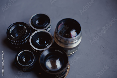 Moscow, Russia - 08 30 2018: retro lenses on gray background. top view, copy space. Close-up shot of lens.