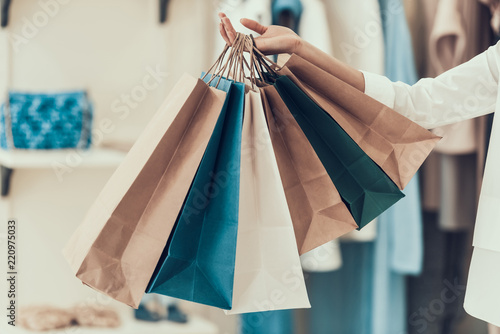 Closeup Young Girl holding Shopping Bags in Store photo
