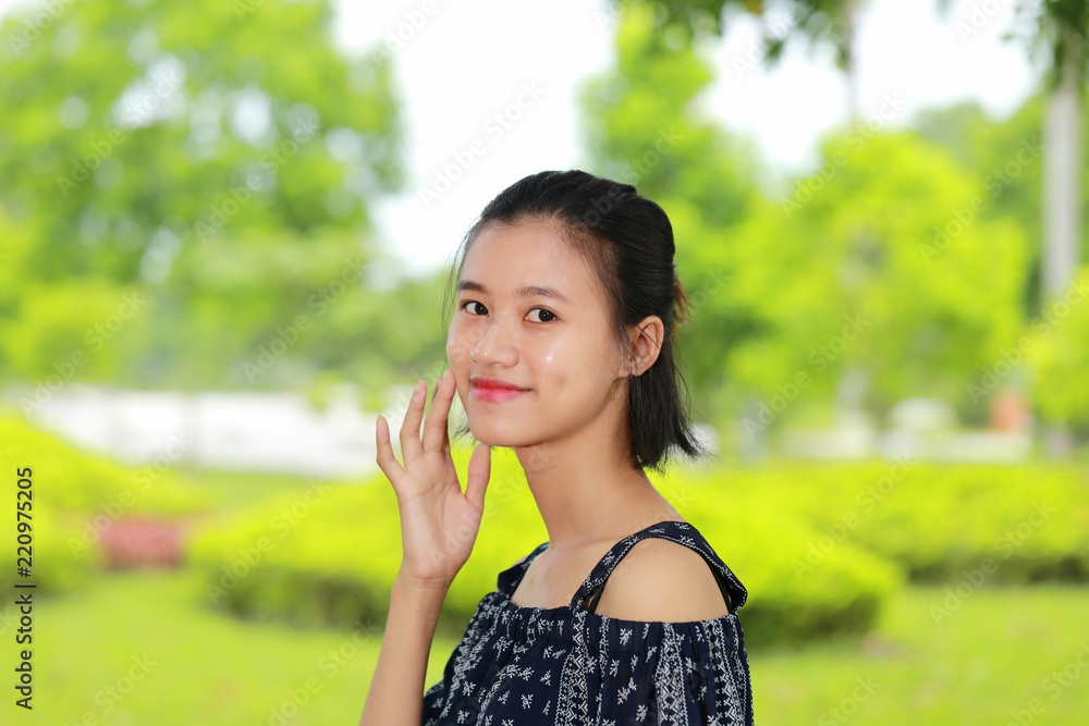 the face of young woman in bright background the face of young woman in bright background