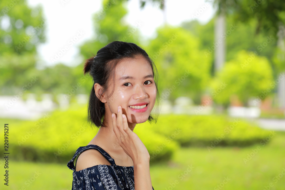the face of young woman in bright background the face of young woman in bright background