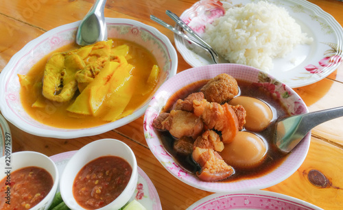 "Kai palo" Sweet stew egg and streaky pork  and "Kaeng som" yellow curry with fish and "Nam prik kapi" spicy shrimp paste dip and rice, Thai food