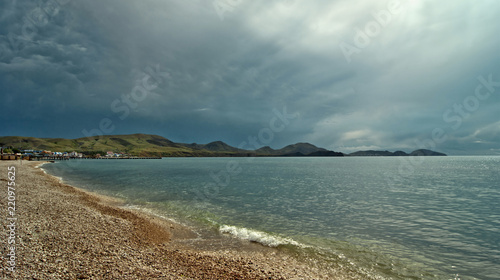 View of the sea landscape with the sky covered by lightning clouds.
